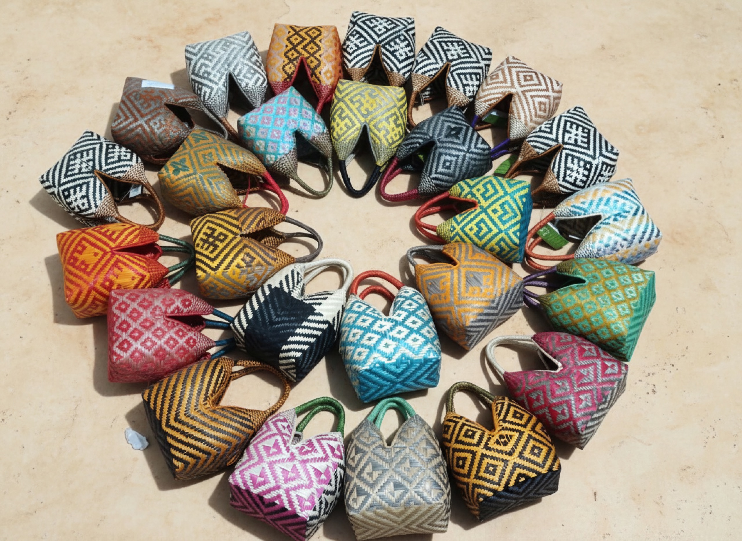Two dozen mini bags in different colorways arranged in a circle